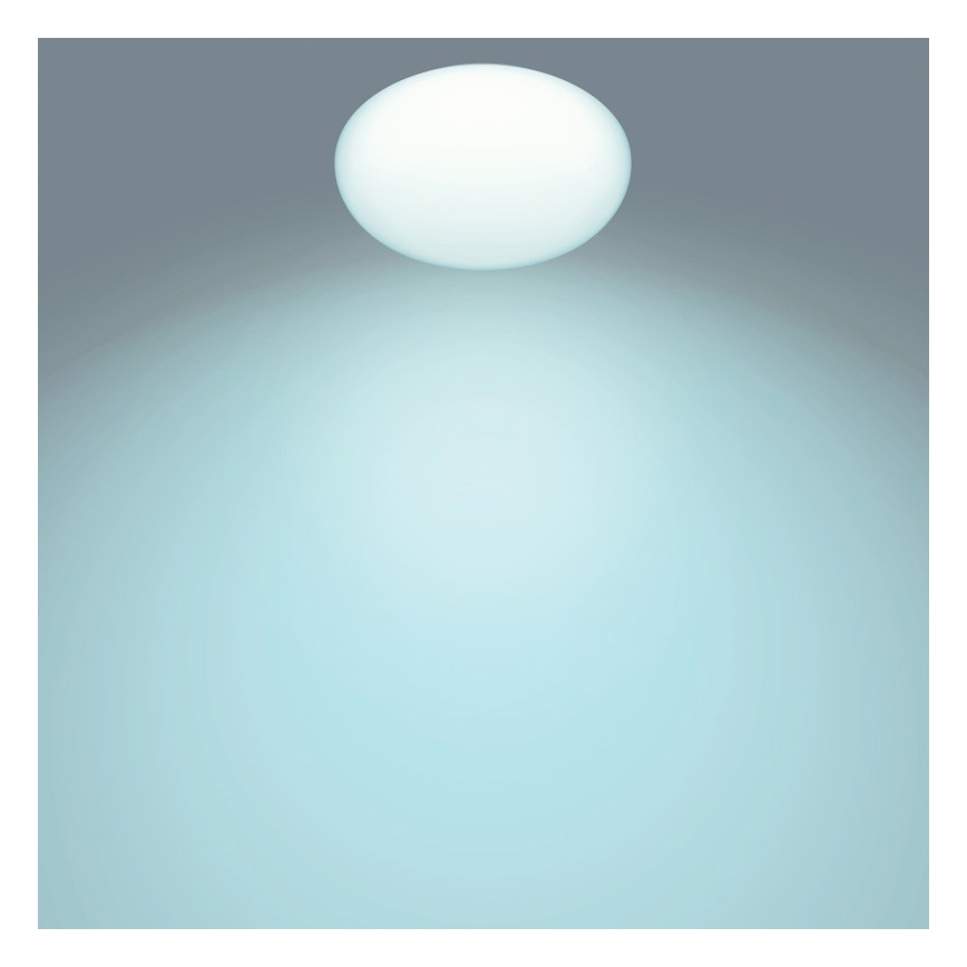 Guľaté svetlo svieti na svetlomodré pozadie. Svetlo je umiestnené v hornej časti obrázka.
