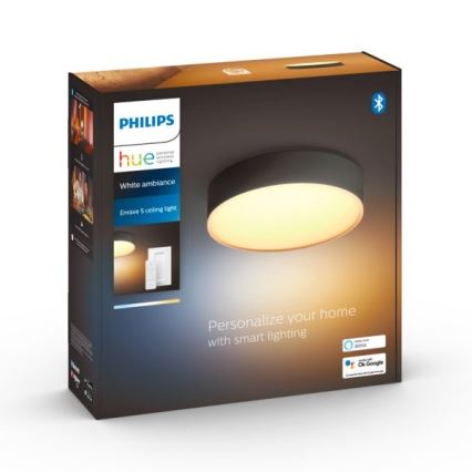 Okrúhle stropné svetlo Philips Hue Enrave S s teplým bielym svetlom je zobrazené v balení. Balenie uvádza kompatibilitu s Amazon Alexa a Google Assistant.