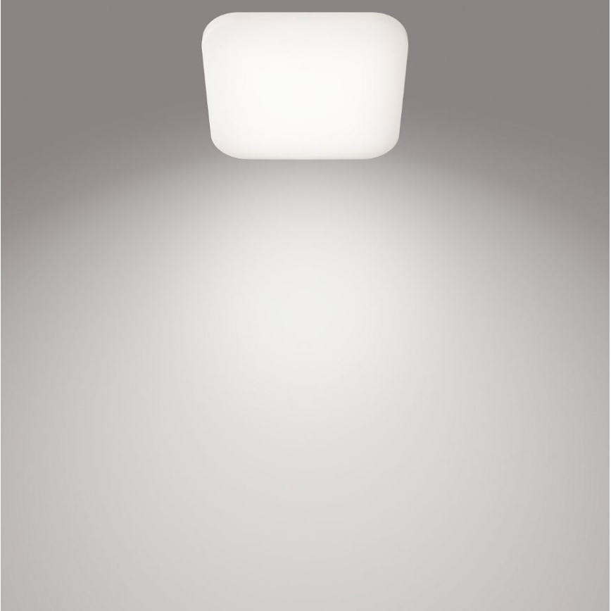 Svietidlo svieti na svetlohnedú stenu. Svietidlo je obdĺžnikové s oblými rohmi a je pripevnené k stropu. Svietidlo vyžaruje svetlo smerom nadol.