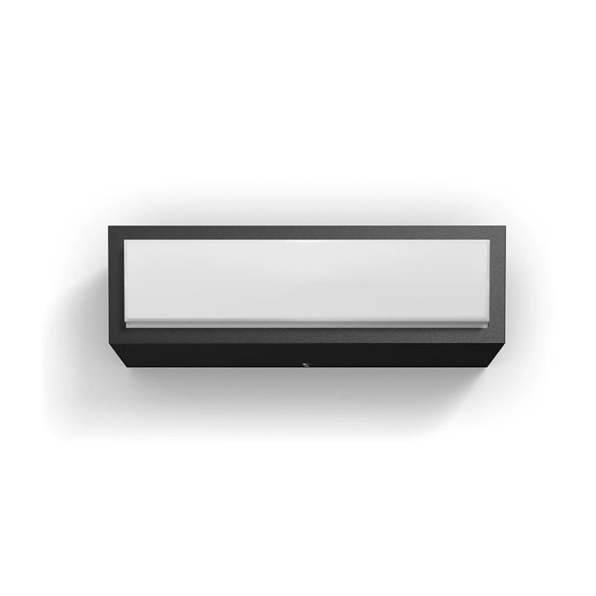 Nástenné svietidlo s obdĺžnikovým tvarom, svieti, je namontované na stene. Svietidlo má čierny rám a biely difúzor.