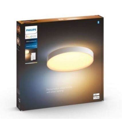 Okrúhle stropné svetlo svieti. Je zabalené v bielej krabici s logom Philips Hue a textom: „Personalize your home with smart lighting“.