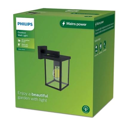 Vonkajšie nástenné svietidlo Philips je zobrazené v obale. Svietidlo je čierne, obdĺžnikové, so sklenenými stenami. Balenie je zelené, s popisom: Outdoor Wall Light, All weather proof, Bulb not included, Mains power a Enjoy a beautiful garden with light.