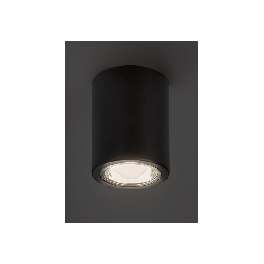 Svietidlo svieti. Je to valcovité, tmavosivé svietidlo pripevnené k stropu. Svetlo vychádza z jeho spodnej časti.