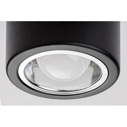 Svietidlo svieti. Je čierne, valcovitého tvaru, s okrúhlym skleneným krytom. Svetlo vychádza z vnútra.