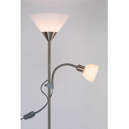 Stojacia lampa s dvoma tienidlami svieti. Hlavné tienidlo je široké, zhora zúžené; druhé je malé, pripevnené na flexibilnom ramene. Na kábli je vypínač.