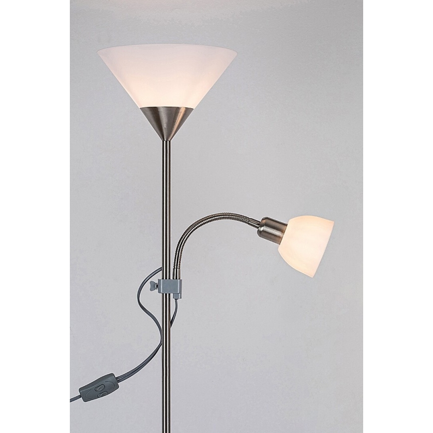 Stojacia lampa s dvoma tienidlami svieti. Hlavné tienidlo je široké, zhora zúžené; druhé je malé, pripevnené na flexibilnom ramene. Na kábli je vypínač.