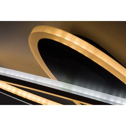 Svietidlo svieti. Oválny tvar s vnútorným čiernym a vonkajším zlatým okrajom je osvetlený LED diódami. Súčasťou je aj ďalší prvok s LED osvetlením.