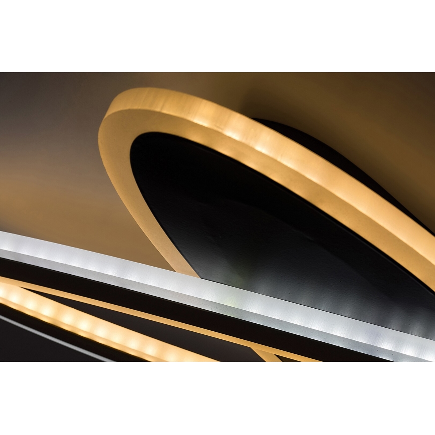 Svietidlo svieti. Oválny tvar s vnútorným čiernym a vonkajším zlatým okrajom je osvetlený LED diódami. Súčasťou je aj ďalší prvok s LED osvetlením.