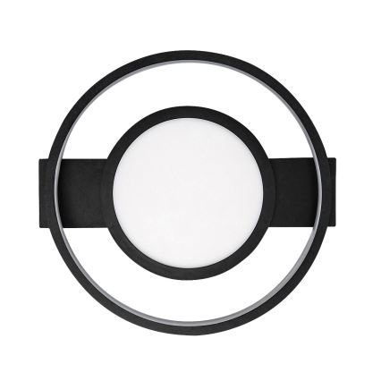 Nástené svietidlo s okrúhlym bielym difúzorom v čiernom kruhovom ráme, ktorý je zasadený do väčšieho čierneho kruhu. Svietidlo je pripevnené k stene.