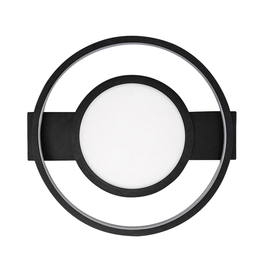 Nástené svietidlo s okrúhlym bielym difúzorom v čiernom kruhovom ráme, ktorý je zasadený do väčšieho čierneho kruhu. Svietidlo je pripevnené k stene.