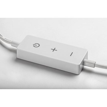 Biela obdĺžniková krabička s káblom má tlačidlá zapnutia/vypnutia a plus/mínus. Leží na svetlom povrchu.