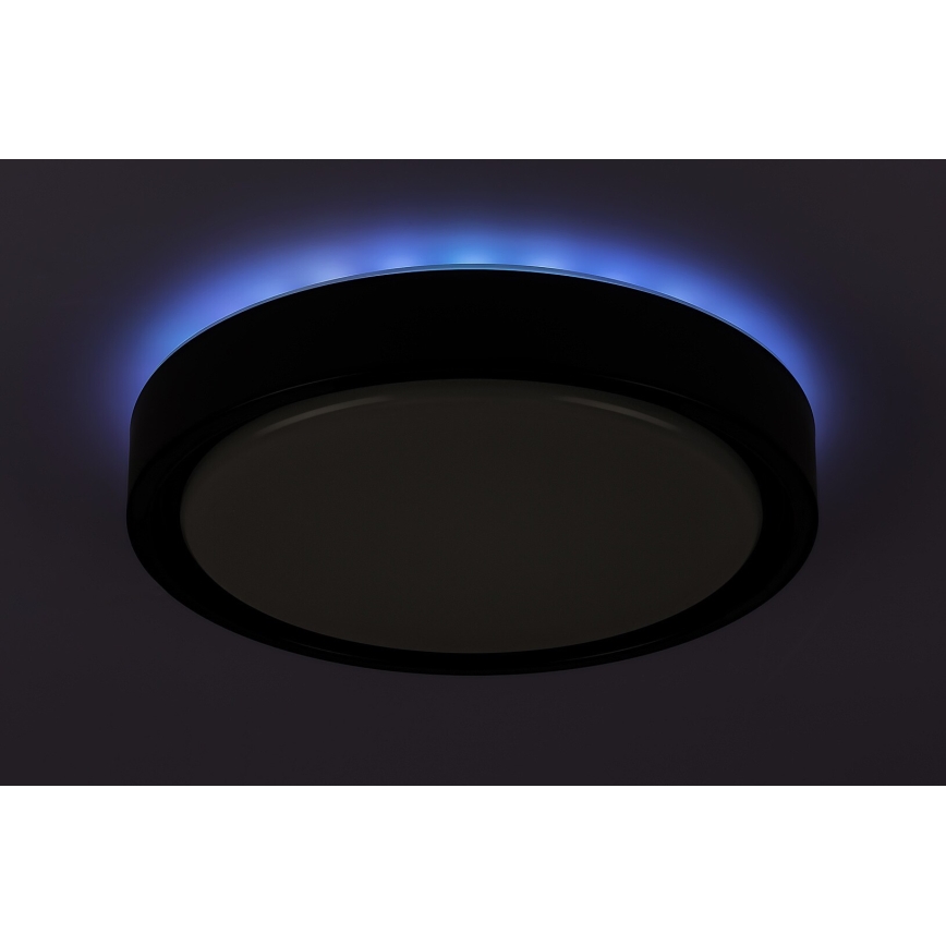 Okrúhle stropné svietidlo svieti. Jeho okraj je osvetlený modrým svetlom. Svietidlo je namontované na strope.