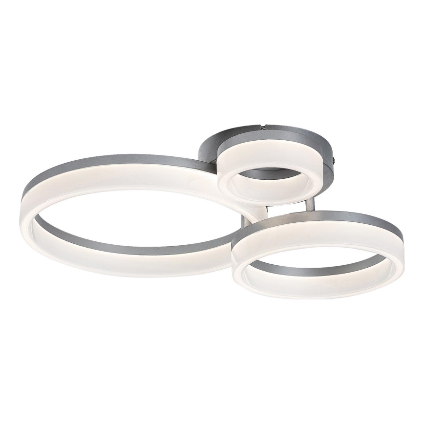 Svietidlo s tromi prepojenými kruhmi, osvetľuje priestor, je z tmavosivej a bielej farby.