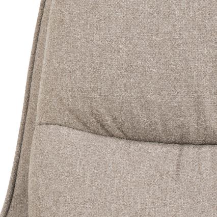 Časť opierky kresla je vyrobená z béžovej látky s prešívanou štruktúrou. Látka má jemnú textúru.