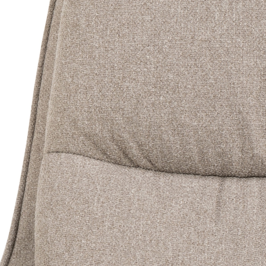 Časť opierky kresla je vyrobená z béžovej látky s prešívanou štruktúrou. Látka má jemnú textúru.