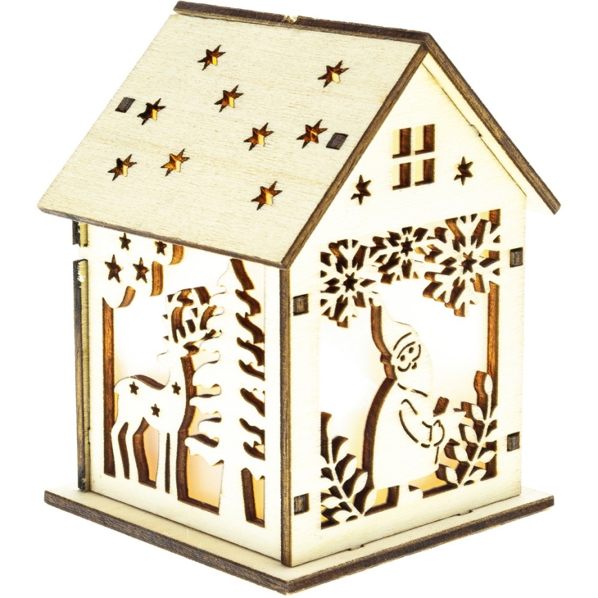 Drevený domček s vyrezávanými vianočnými motívmi (jeleň, snehuliak, stromy, snehové vločky) svieti zvnútra. Domček stojí na bielom pozadí.