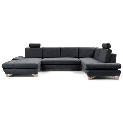 Rohová sedačka s opierkami hlavy stojí na bielom pozadí. Sedačka je tmavosivá, s drevenými nožičkami. Je rozložená do tvaru písmena U.