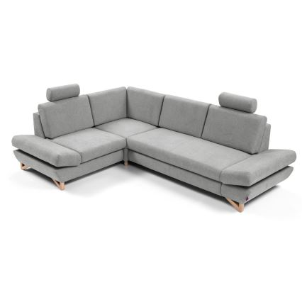 Rohová sedačka s opierkami hlavy je umiestnená na bielom pozadí. Sedačka je sivá a má drevené nohy. Je rozložená do tvaru L.