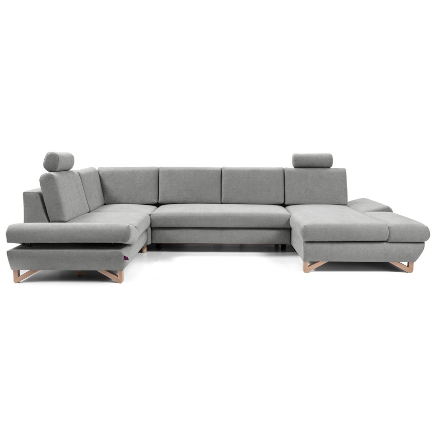 Rohová sedačka v tvare U, sivá, stojí na drevených nožičkách. Je rozdelená na niekoľko častí, má opierky hlavy. Nachádza sa na bielom pozadí.