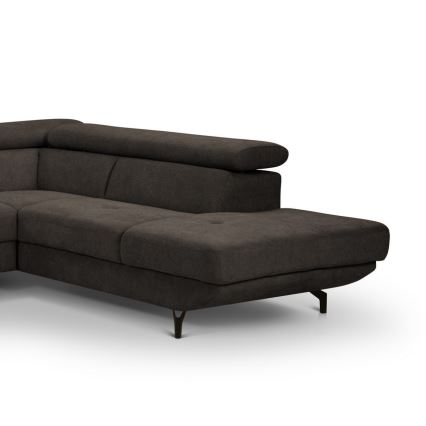 Rohová sedačka tmavosivej farby stojí na štyroch tmavých nohách. Sedačka je čalúnená a má výrazné prešívanie. Je umiestnená na bielom pozadí.