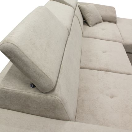 Rohová sedačka s nastaviteľnými opierkami hlavy je čalúnená svetlo béžovou látkou. Opierky sa dajú sklápět. Sedačka má gombíkové prešívanie na sedákoch.