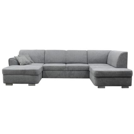 Rohová sedačka sivá s podrúčkami a vankúšom je umiestnená na bielom pozadí. Sedačka je rozsiahla, s viacerými sedacími časťami. Je zhotovená z látky.