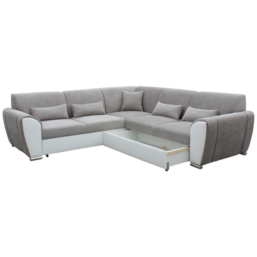 Rohová sedačka s výsuvným úložným priestorom je umiestnená na bielom pozadí. Sedačka je čalúnená sivou látkou a bielou koženkou. Je vybavená viacerými vankúšmi.