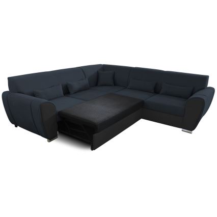 Rohová sedačka s výsuvným lôžkom je čiastočne tmavomodrá a čiastočne čierna. Sedačka má niekoľko vankúšov a je umiestnená na bielom pozadí.