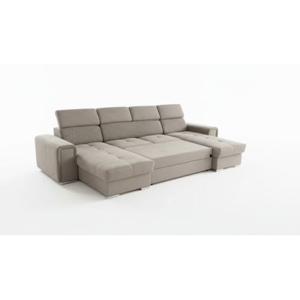 Rohová sedačka je čiastočne viditeľná. Je tmavosivej farby, z materiálu s pozdĺžnymi rebrami a hladkým povrchom. Sedačka má výrazné prešívanie.