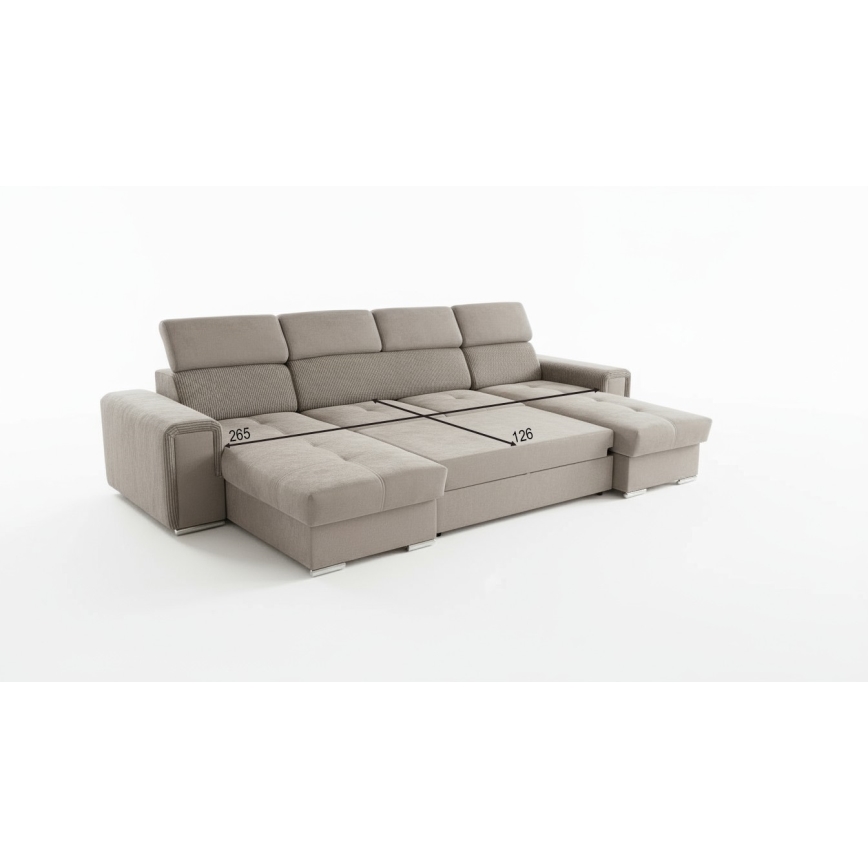 Rohová sedačka je zobrazená z mierne zvýšeného uhla. Rozmery sú vyznačené: 265 a 130. Sedačka je svetlohnedá, rozdelená na niekoľko častí. Nachádza sa na bielom pozadí.