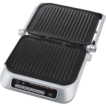 Elektrický gril s otváracími grilovacími plochami je pripravený na použitie. Ovládací panel obsahuje tlačidlá pre rôzne druhy potravín (Steak, kuracie, klobása, ryby, hamburger) a nastavenie prepečenia (rare, medium, medium well, well done).