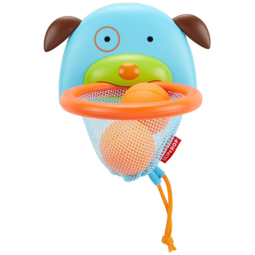 Plastová hračka v tvare hlavy psa má pripevnenú košíkovú sieť s dvoma oranžovými loptičkami. Hračka je určená na hádzanie loptičiek. Na sieti je logo SKIP HOP.