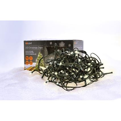 Vianočná LED svetelná reťaz leží na umelom snehu vedľa svojej krabice. Krabica obsahuje text: SOLIGHT LED Christmas Chain, Warmweiß LED, Variabilná LED reťaz, 60x, 8, 10m, IP44.