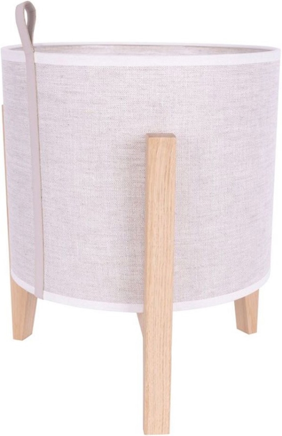 Stojacia lampa stojí na štyroch drevených nohách. Jej tienidlo je valcovité, z béžovej látky s koženým uškom. Tienidlo je lemované bielym pásikom.