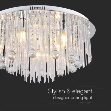 Stropné svietidlo svieti. Je kruhového tvaru, z chrómovaného kovu, ozdobené visiacimi kryštáľovými prvkami a tyčinkami. Text pod svietidlom: „Stylish & elegant designer ceiling light“.
