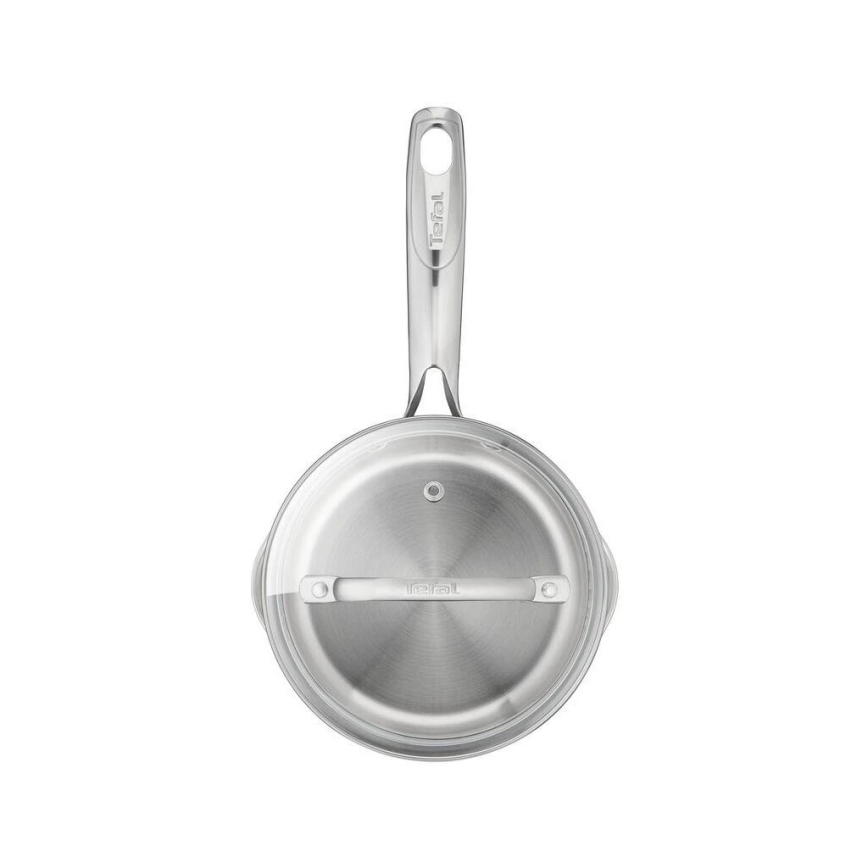 Nerezový hrniec s pokrievkou je zobrazený zhora. Hrniec má rukoväť s vyrytým nápisom „Tefal“. Pokrievka je priehľadná, s vnútornou rukoväťou s logom „Tefal“. Biele pozadie.