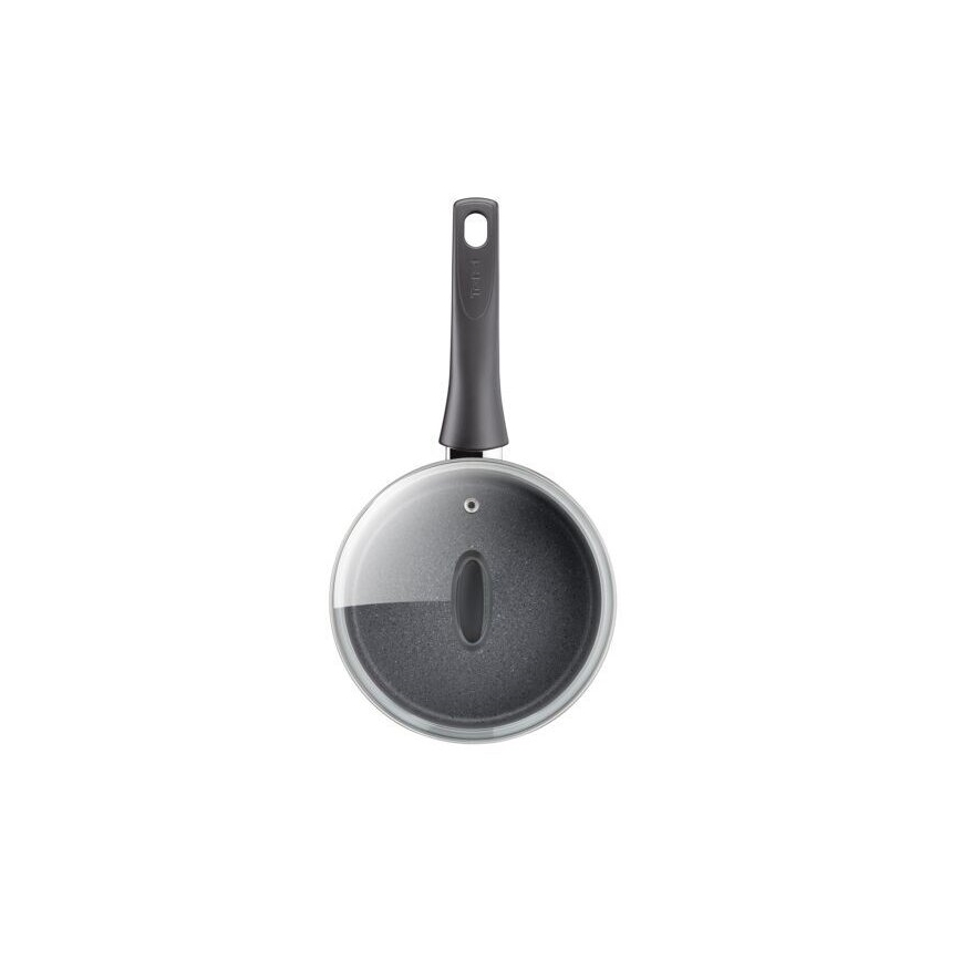 Malá tmavosivá panvica s priehľadnou sklenenou pokrievkou a tmavosivou rukoväťou s nápisom „Fissler“ je zobrazená zhora. Panvica je prázdna a je umiestnená na bielom pozadí.