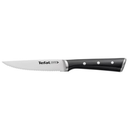 Nôž Tefal s pílkovým ostrim a čiernou rukoväťou s bielymi bodkami leží na bielom pozadí.