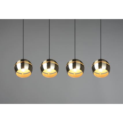 Štyri guľové svietidlá visia zo stropu. Svietidlá sú zlatohnedé s tmavými čiernymi káblami. Svetlo presvitá cez vnútorné prvky. Pozadie je sivé.