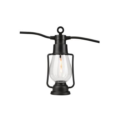 Čierna lampášová lampa s priehľadným sklom a rozžiarenou žiarovkou je pripojená k čiernemu elektrickému káblu.