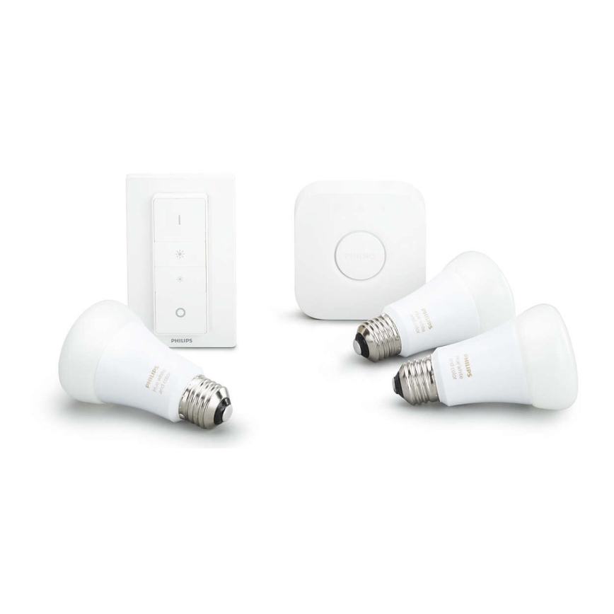 Tri biele LED žiarovky Philips a stmievač s dotykovým ovládaním sú položené na bielej ploche. Okrem toho je tam aj štvorcový bezdrôtový prepínač.