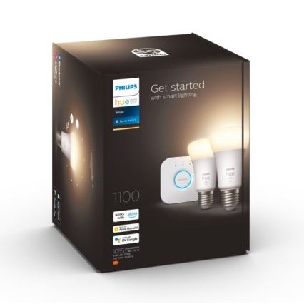 Balenie inteligentného osvetlenia Philips Hue obsahuje dve LED žiarovky a ovládač. Balenie je tmavé, s bielym logom a textom Get started with smart lighting, works with Alexa, Apple HomeKit, OK Google. Čísla 1100 a 1055 sú tiež uvedené.