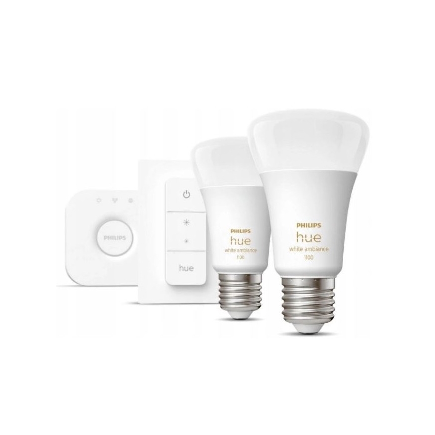 Dve LED žiarovky Philips Hue white ambiance 1100, spínač a diaľkové ovládanie. Žiarovky sú umiestnené na bielom pozadí.